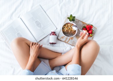 Young Woman Eating Healthy Breakfast In Bed 