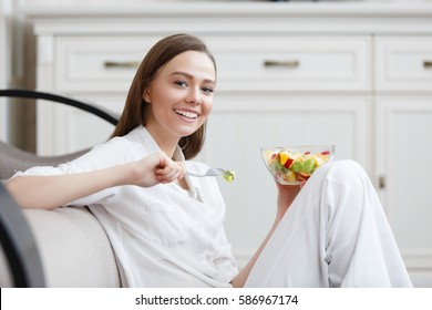 Young Woman Eating Healthy Fruit Breakfast In Bowl At Home. Healthy Food. Clean Eating, Dieting, Detox, Vegetarian Food Concept.