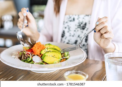 Young woman eating healthy salad at restuarant, Healthy lifestyle, diet concept