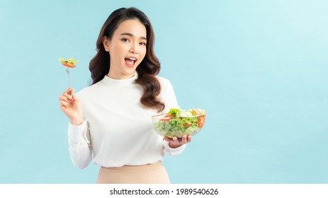 Young Woman Eating A Healthy Salad