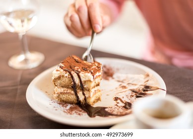 Young Woman Eating Homemade Traditional Dessert Tiramisu With Coffee And Glass Of Wine