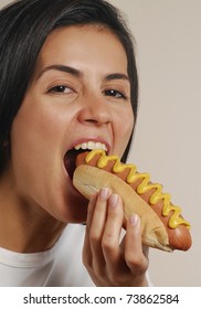 Young Woman Eating Hot Dog.