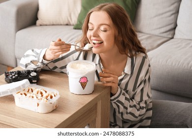 Young woman eating ice cream at home - Powered by Shutterstock