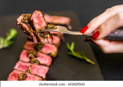 Young Woman Eating New York Strip Porterhouse Steak Meat