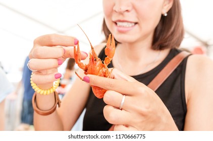 Young Woman Eating Red Boiled Delicious Crayfish Or Crawfish River Lobster. Local Cuisine And Seafood Concept