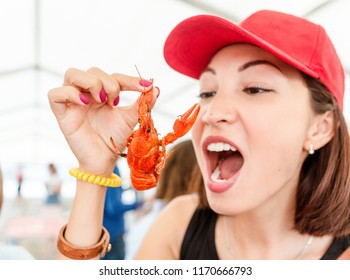 Young Woman Eating Red Boiled Delicious Crayfish Or Crawfish River Lobster. Local Cuisine And Seafood Concept