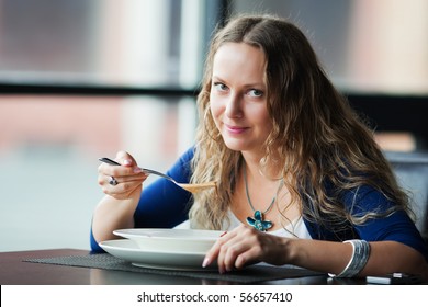 Young Woman Eating Soup.