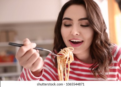 Young Woman Eating Tasty Pasta At Home