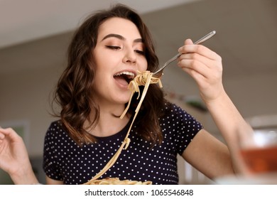 Young Woman Eating Tasty Pasta In Cafe