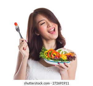 Young Woman Eating A Vegetable Salad On White Background