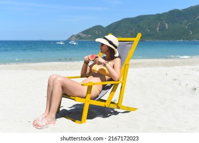 Young Woman Eating Watermelon On Sandy Beach In Vietnam