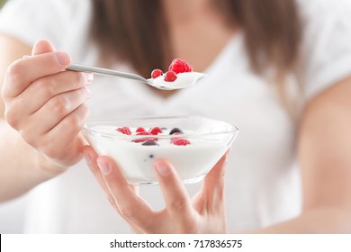 Young Woman Eating Yogurt, Closeup