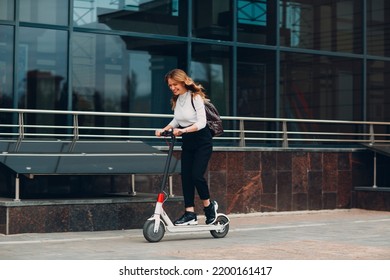 Young Woman With Electric Scooter At The City.