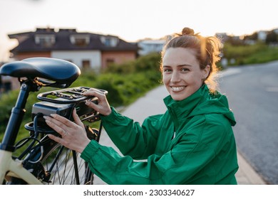 Young woman with electro bicycle, concept of commuting and ecologic traveling. - Powered by Shutterstock