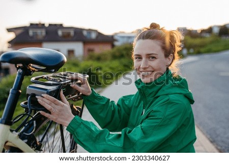 Young woman with electro bicycle, concept of commuting and ecologic traveling.