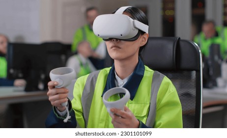 Young woman engineer test vr goggles and controllers in modern industrial laboratory. Technician working in augmented reality headset - Powered by Shutterstock