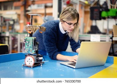 Young Woman Engineer Working On Robotics Project