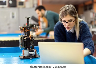 Young Woman Engineer Working On Robotics Project