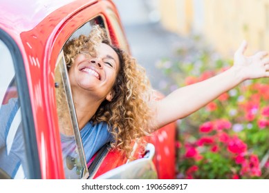 Young woman enjoy drive the car and travel - happy people female dricing vehicle and having fun - concept of female and automobile - free person traveling and laughing