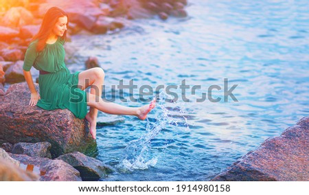 Young woman enjoy happy life at morning sunrise. Girl feel well in lake water on free beach. Summer nature beauty, people health, good sea travel relax, sun energy peace view, person live joy concept.