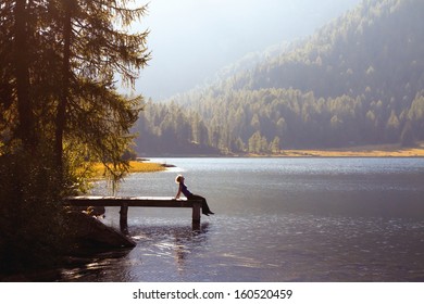young woman enjoy the nature on the mountain lake