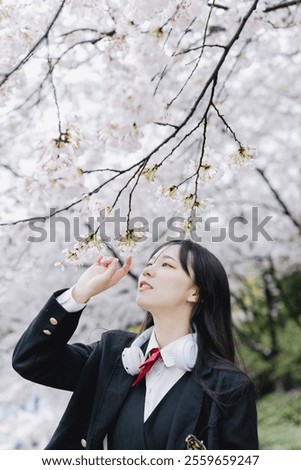 Similar – Image, Stock Photo Young woman enjoying cherry blossoms in springtime