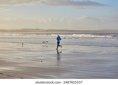 A young woman enjoying a coastal jog along Essaouira's oceanfront, with the Atlantic waves providing a serene backdrop to her invigorating run - Powered by Shutterstock