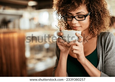 Young woman enjoying a coffee at a cafe [[stock_photo]] © 