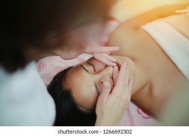 Young woman enjoying facial massage in spa salon. Spa skin and body care. Facial beauty treatment. Cosmetology, beauty concept. - Shutterstock ID 1266692302
