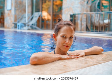 Young woman is enjoying and having relax in an outdoor privite swimming pool in summer vacation