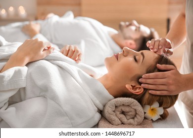 Young Woman Enjoying Head Massage In Spa Salon