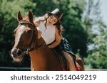 Young woman enjoying a leisurely horseback ride outdoors on a sunny day, highlighting equestrian activities and relaxation.