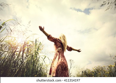 young woman enjoying nature in the middle of a meadow, welcome warm season