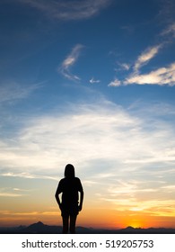 Young woman enjoying outdoors, sky background,sunset