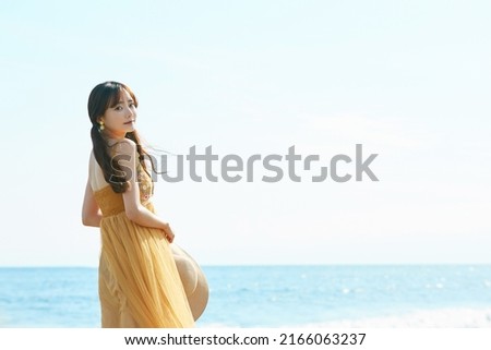 Young woman enjoying the resort on the beach