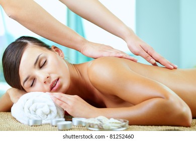 A young woman enjoying spinal massage