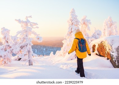 Young woman enjoying stunning view over winter forest with snow covered trees in Lapland Finland - Powered by Shutterstock