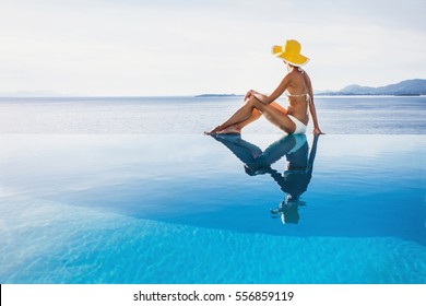 Young woman enjoying a sun at infinity pool. Enjoy life, vacations, holidays, sunbathing, travel, relaxation, self care, resting, leisure, recreation, healthy active lifestyle, summer fun concept