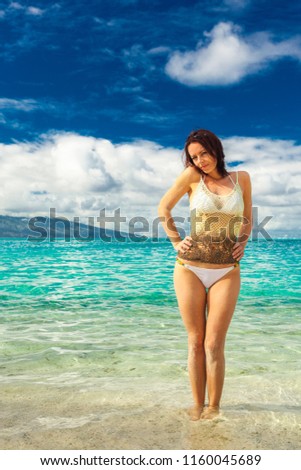 Young woman enjoying tropical beach holidays at Moorea and Tahiti, French Polynesia