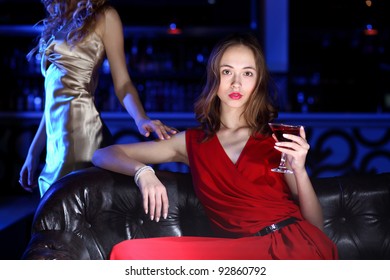 Young woman in evening dress in night club with a drink - Shutterstock ID 92860792