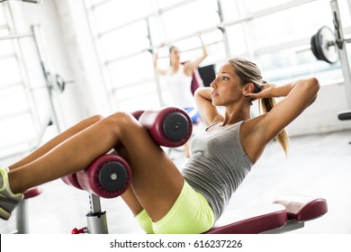 Young Woman Exercise Abs In The Gym On The Bench