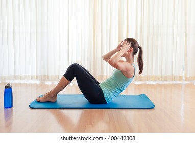 Young woman exercising. (Sit up exercise) Abs core workout. 