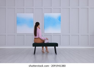 Young woman at exhibition in art gallery, back view - Powered by Shutterstock