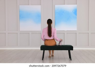 Young Woman At Exhibition In Art Gallery, Back View