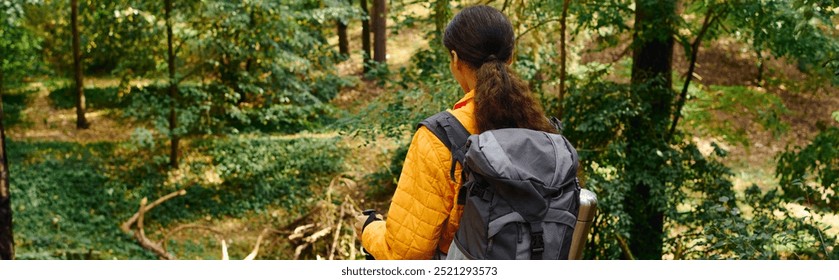 A young woman explores the beauty of a forest in autumn, immersed in nature and adventure. - Powered by Shutterstock