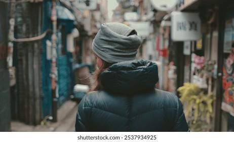 Young woman exploring tokyo's charming streets, immersing in local culture and vibrant atmosphere. Discovering traditional buildings, quaint shops, and authentic japanese life - Powered by Shutterstock