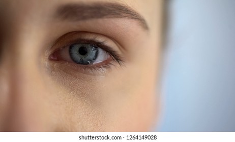 Young woman eye full of tears, bullying and violence concept, problems, close up
