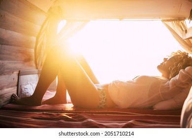 Young Woman In Eyeglasses Sleeping In Van. Beautiful Woman Enjoying Vacation On Road Trip.  Silhouette Of Woman In Underwear Relaxing In Car During Holiday Road Trip