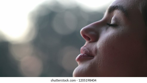 Young Woman Face Eyes. Girl Meditating And In Contemplation Looking Up To The Sky With Hope And Faith