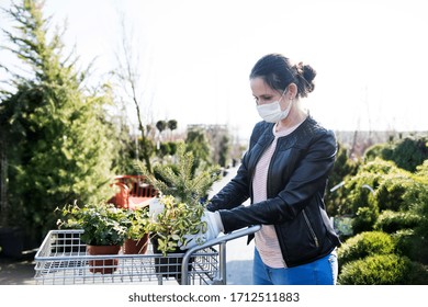 Young Woman With Face Mask Outdoors Shopping In Garden Center, Corona Virus Concept.